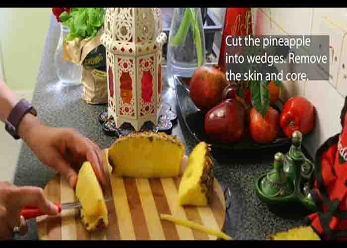 Chopping the pineapple into wedges