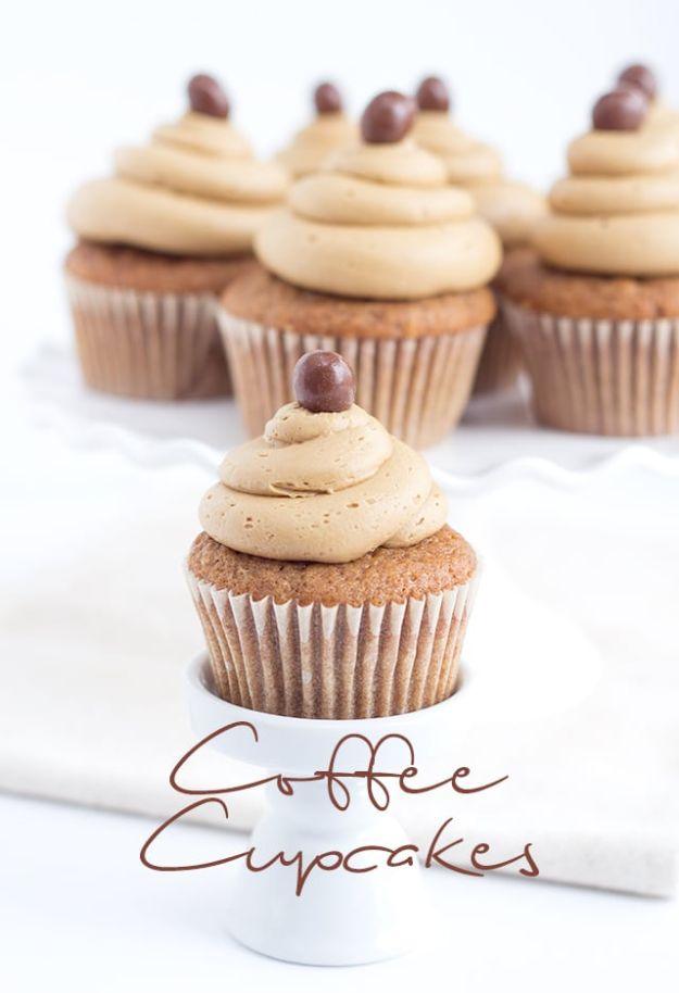 Coffee cupcakes with tall swirls of coffee buttercream each topped with a chocolate covered coffee bean