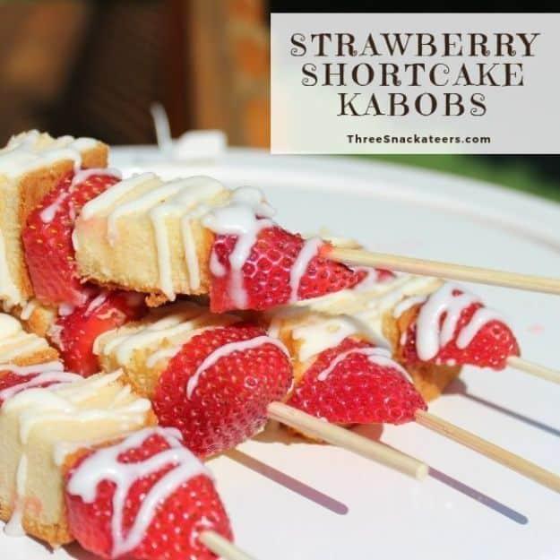 Strawberry shortcake kabobs on wooden skewers with pound cake cubes and berries drizzled with white icing