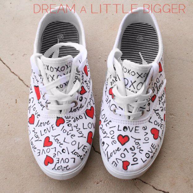 White canvas sneakers doodled with red hearts and the word love in fabric marker for Valentine's Day