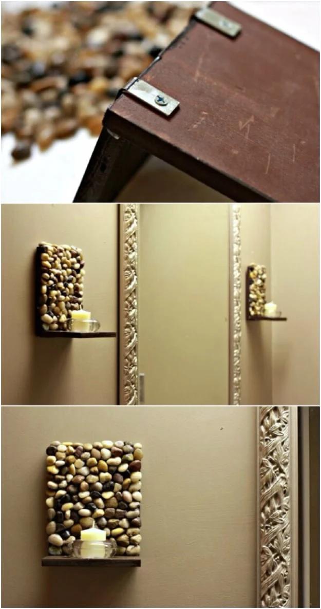 Stone covered wall sconces with tealight shelves mounted on a beige wall, with a construction detail shown above