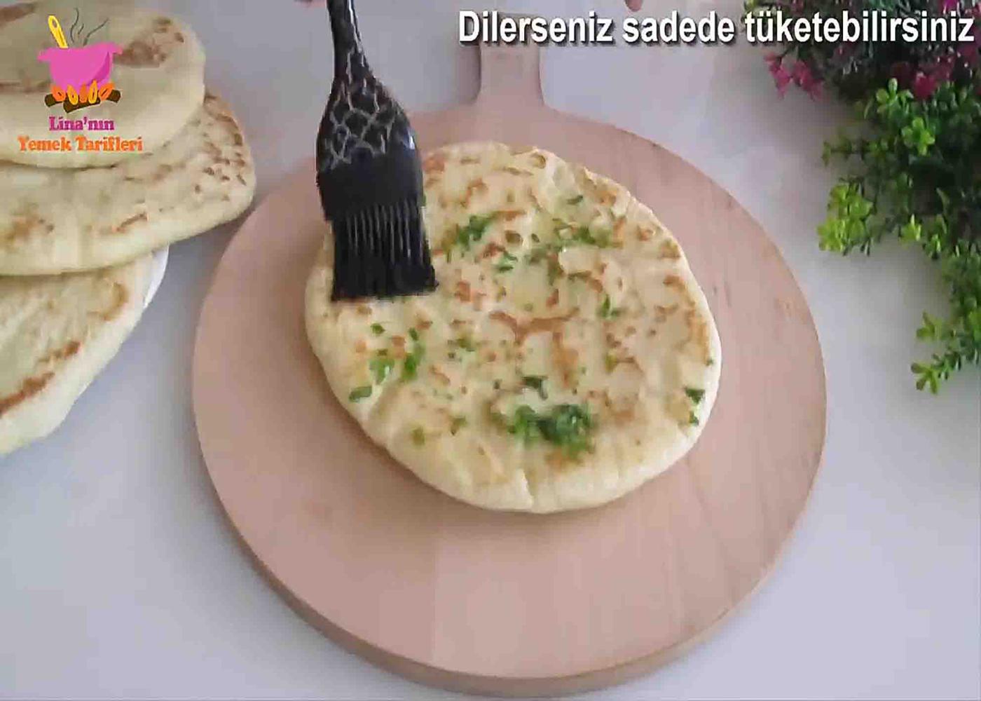 Buttering up the flatbreads ready to be serve