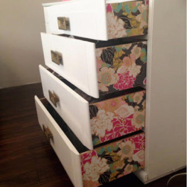 DIY wallpaper dresser, four open white drawers with black pink and gold floral wallpaper covering the outside faces