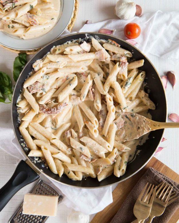 Penne alfredo tossed with crispy bacon and sundried tomato for a rich indulgent weeknight dinner for the whole family
