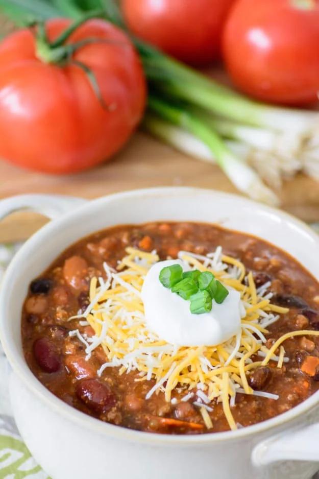 Thirty minute chili with ground beef, kidney beans, black beans and crushed tomatoes in a big pot ready to serve at home