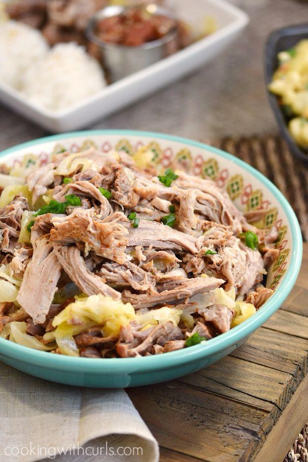 Turquoise patterned bowl of shredded kalua pork mixed with cabbage with a dish of white rice behind it