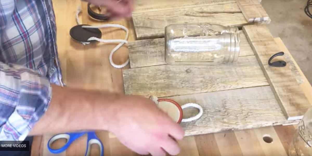 He Uses Pallet Wood And A Mason Jar To Make An Amazing Item For His Decor That You’re Gonna Want!
