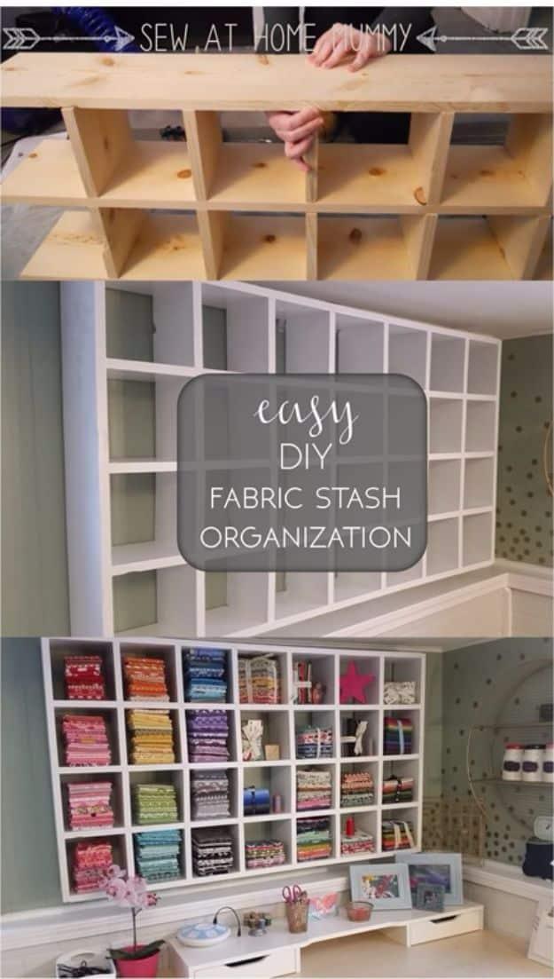 White wall cubby of seven inch squares filled with fabric folded by color, shown mid build and finished above a desk