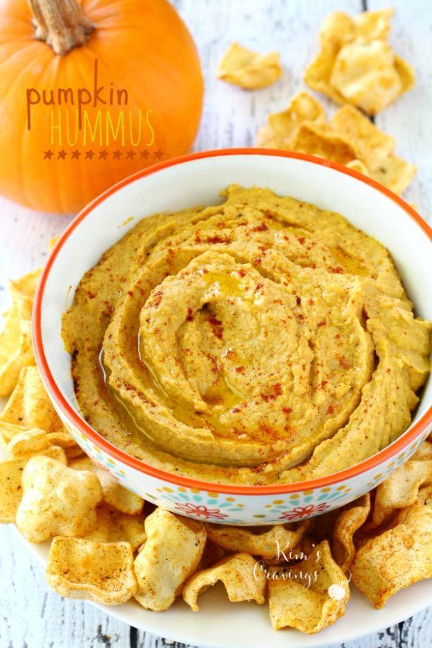 Pumpkin hummus in a bowl with olive oil drizzled over, smoked paprika and pumpkin seeds sprinkled on top