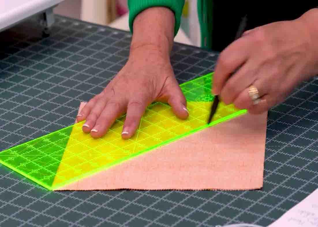 Drawing a line diagonally to make the blocks for the carpenter's star quilt