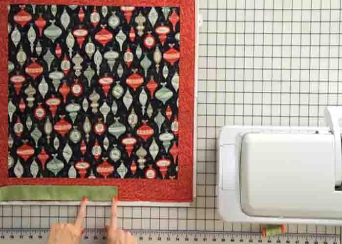 Aligning the binding strip on top of the quilt top