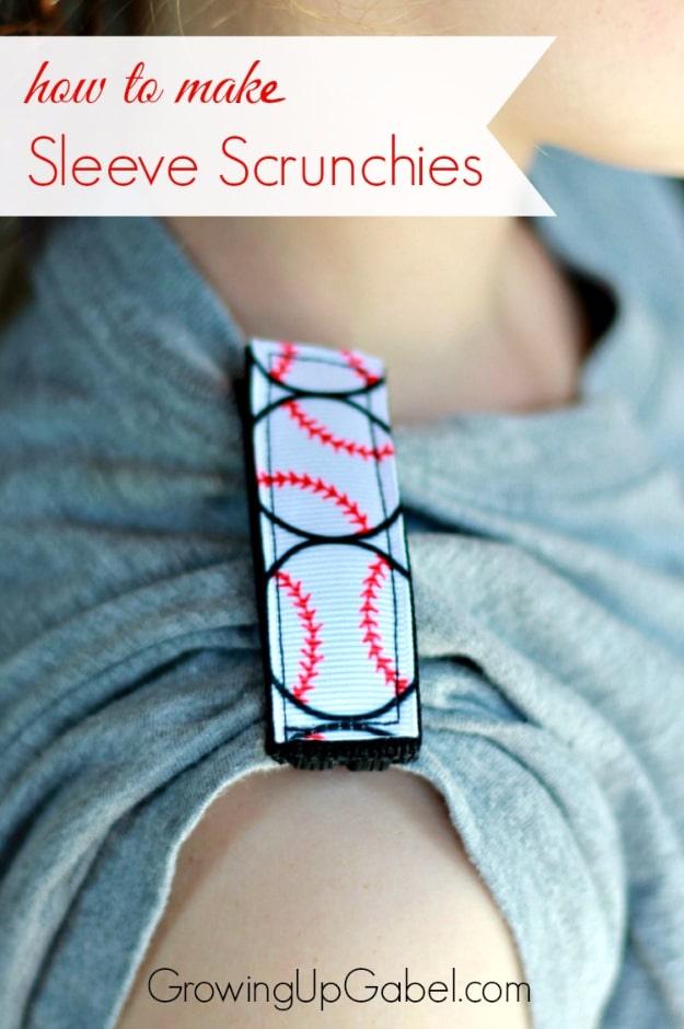 Sleeve scrunchie in baseball print ribbon fastened around a rolled gray sleeve on a child's upper arm