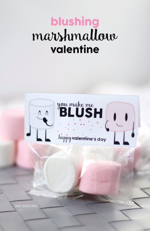 Marshmallows dipped in pink chocolate with sprinkles packaged in a clear bag as a Valentine gift for a handmade gift