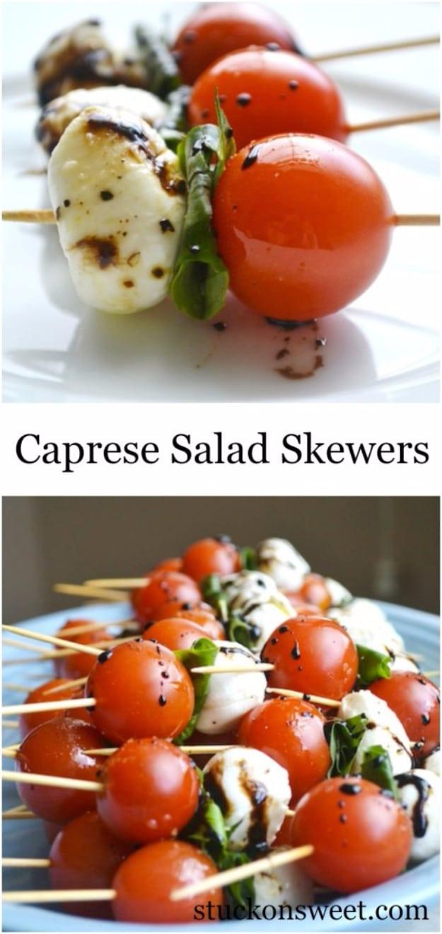 Caprese salad skewers party appetizer with cherry tomatoes, rolled basil and mozzarella in balsamic glaze