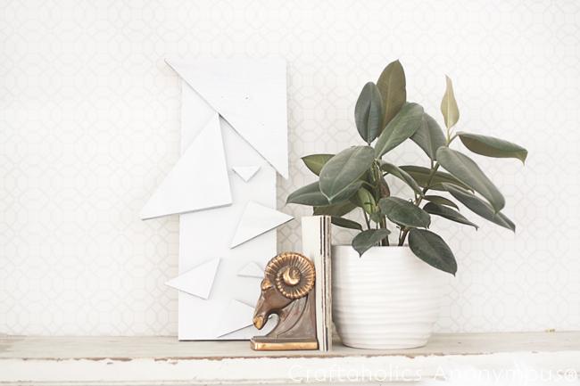 Modern triangle geometric wall art made from wood shapes and spray paint, an easy DIY bedroom wall decor idea