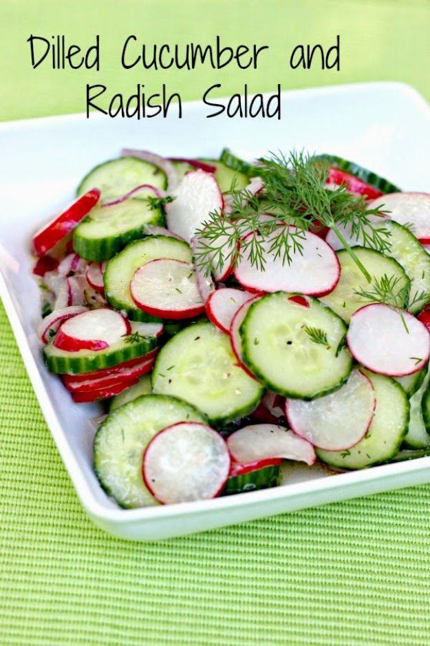 Dilled cucumber and radish salad in a white dish with sliced cucumber, red radish rounds and fresh dill