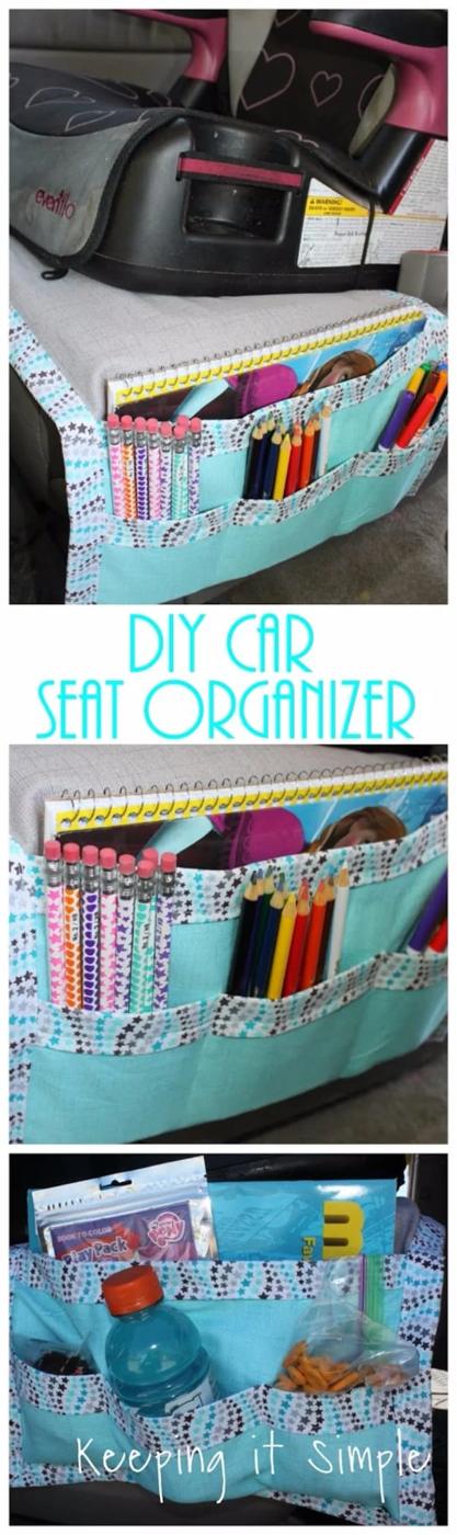Car seat caddy in pale gray and blue cotton with open front pockets holding colored pencils, a notebook and snacks