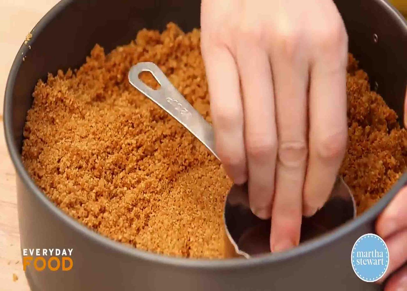 Setting the cheesecake crust into the pan
