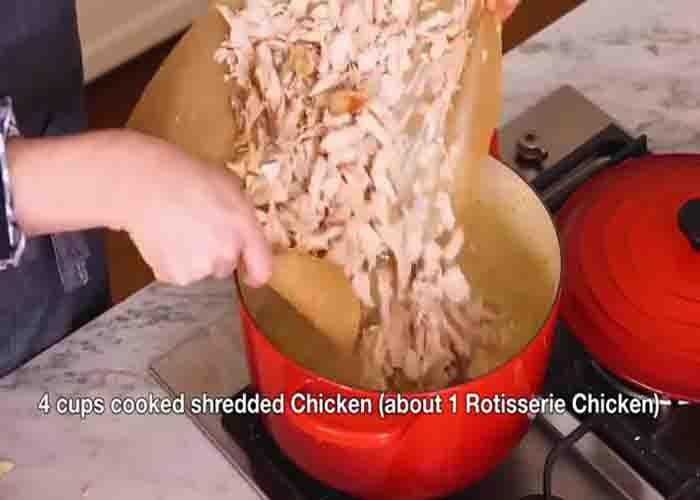 Adding the shredded chicken to the pot pie soup