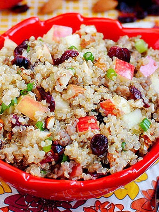 Quinoa with apple, cranberries, sliced almonds, green onion and maple sausage in a colorful serving bowl
