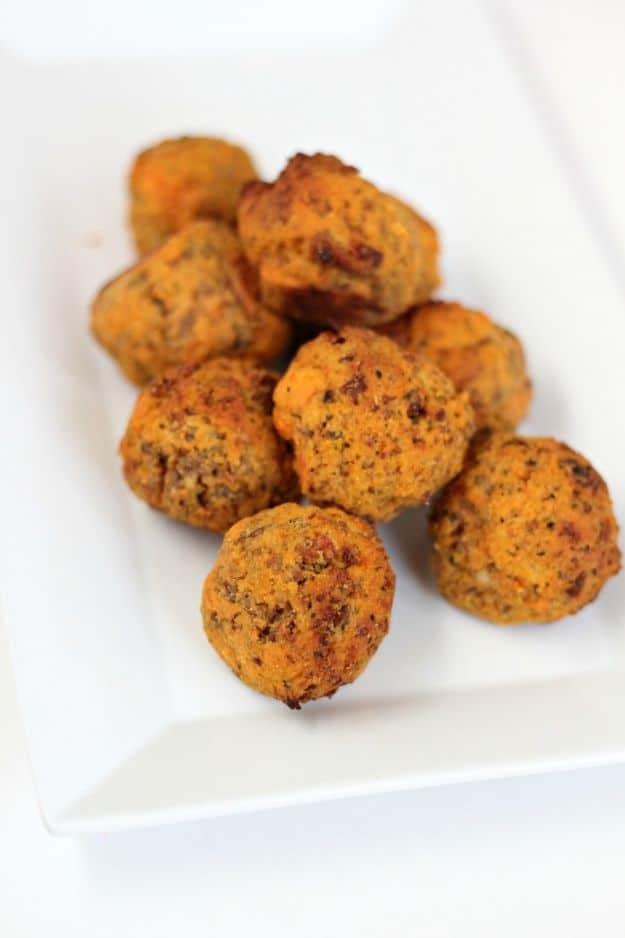 Paleo sausage balls made with sweet potato and coconut flour, baked golden on a tray, a gluten free appetizer