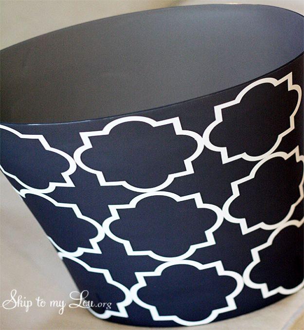 Navy oval trash can patterned with white quatrefoil outlines in vinyl, photographed close against a pale background
