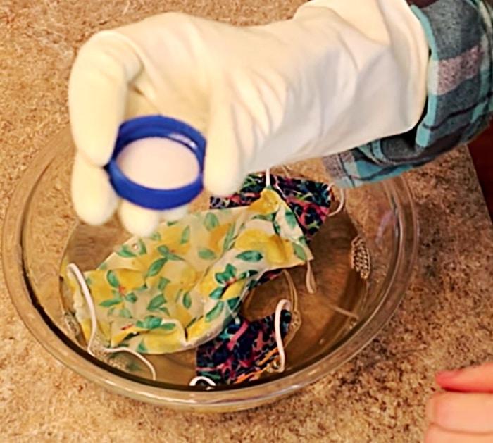 Use bleach and soap to sterilize a face mask