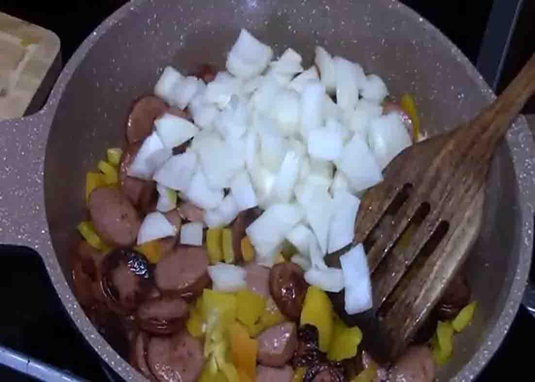 Cooking the ingredients for the one-skillet sausage and cheesy rice