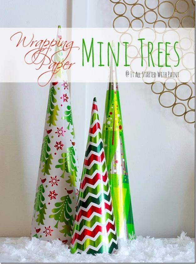 Wrapping paper mini trees graphic with three paper covered foam cones in Christmas prints standing in fake snow
