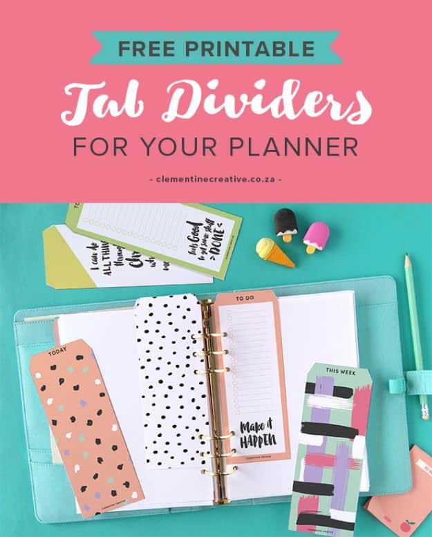 Free printable tab dividers and bookmarks laid in a turquoise ring planner with a pencil on a teal desk