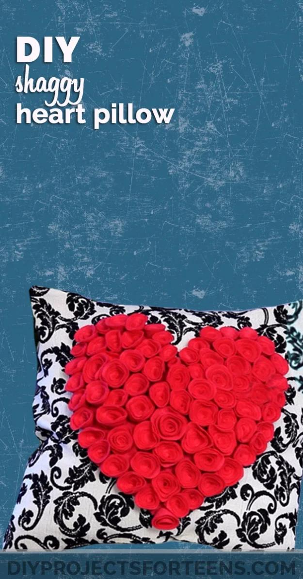 DIY shaggy heart pillow, a red fabric rose heart massed on a black and white damask cushion, on a teal ground