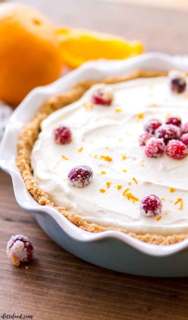 No bake cranberry orange cream pie with swirled cranberry sauce, orange cream filling and graham crust
