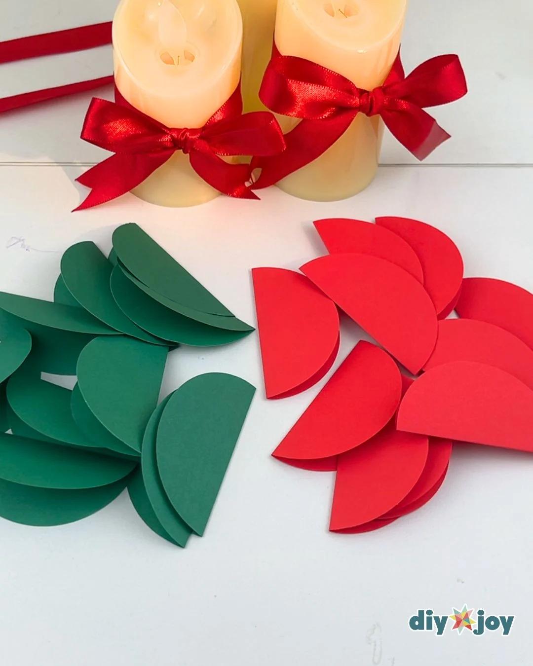 Cheap DIY - two loose piles of folded paper half circles, one dark green and one red, on a white table