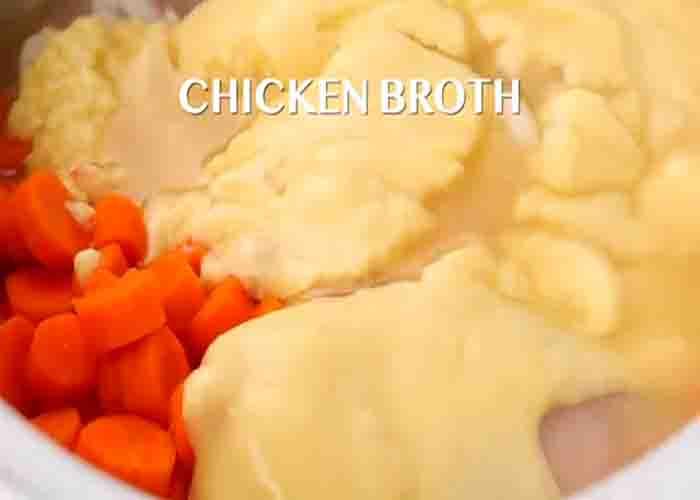 Adding the chicken and noodles ingredients to the slow cooker