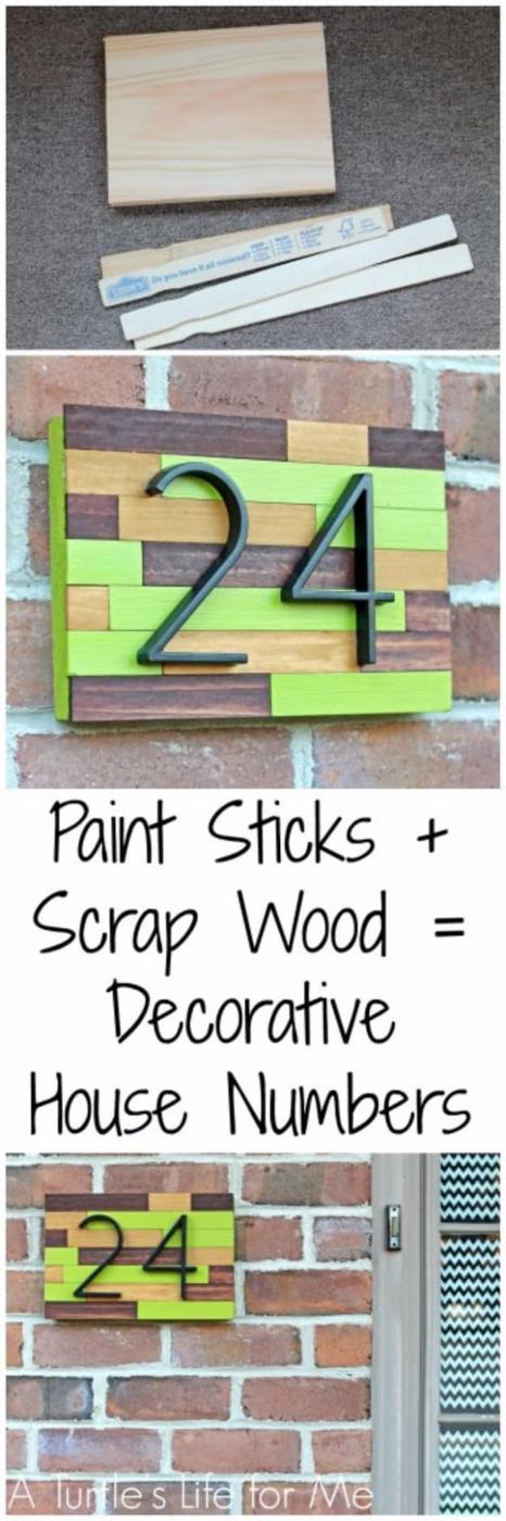 DIY curb appeal house number plaque built from painted and stained paint sticks with black numerals mounted on brick