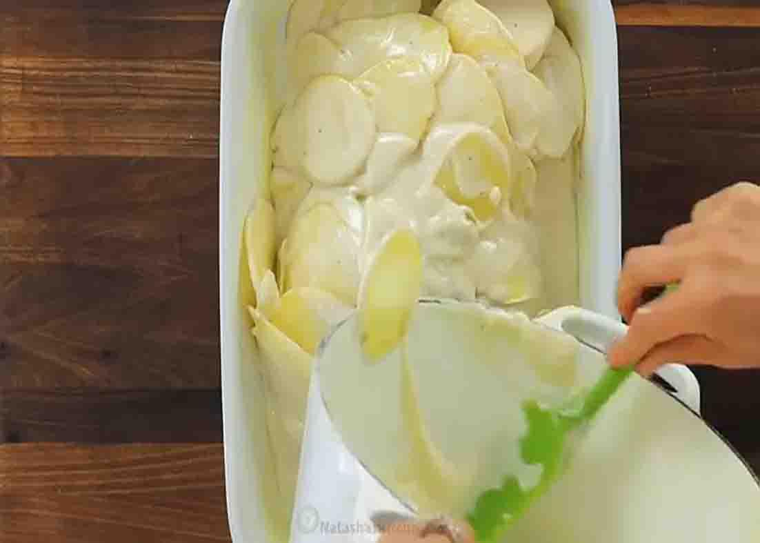Assembling the au gratin potatoes casserole