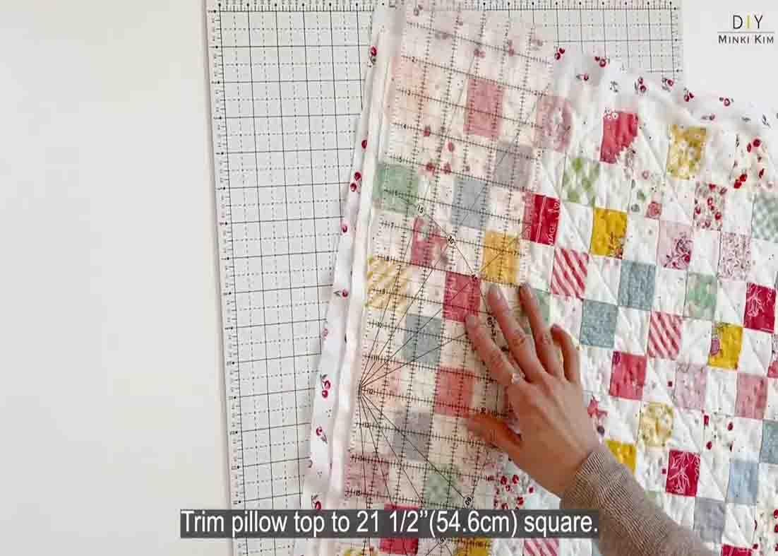 Trimming the raw edges of the quilted pillow cover