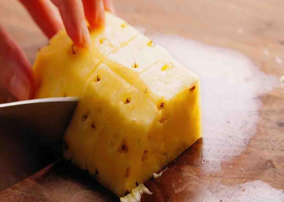 Slicing the pineapple for the pina colada smoothie