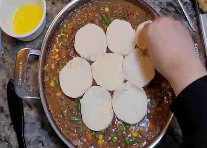Adding the biscuits to the beef pot pie