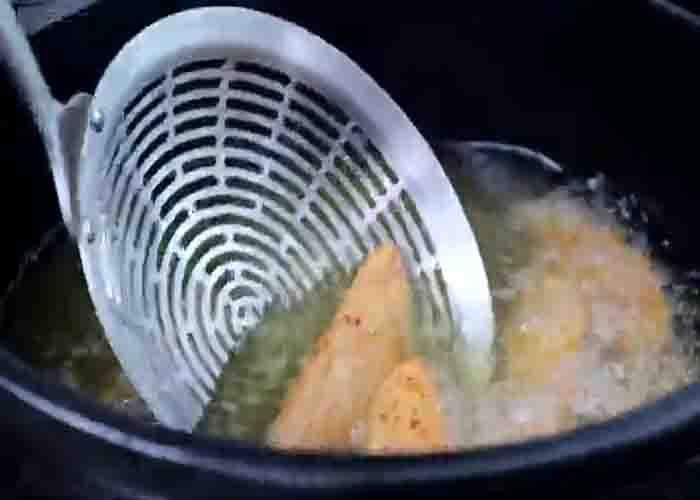 Deep frying the potato wedges