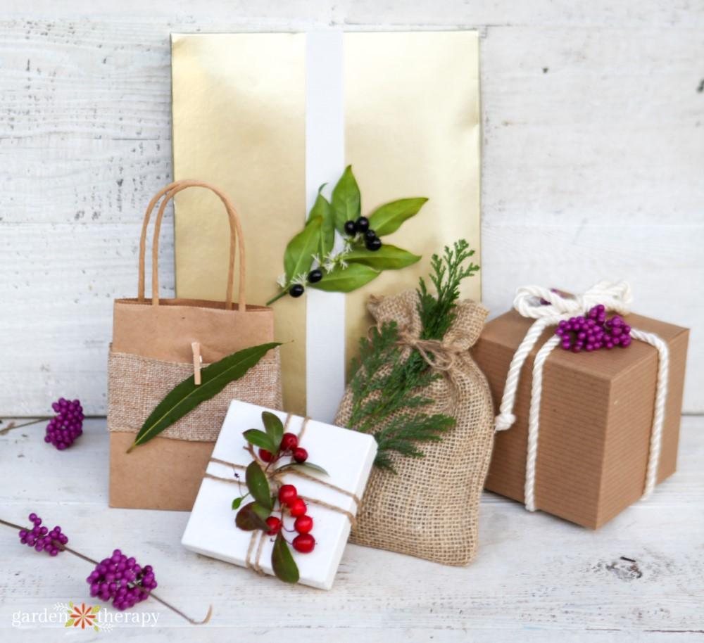Kraft, white and gold wrapped gifts and a burlap sack trimmed with fresh cedar, bay leaves and bright berries