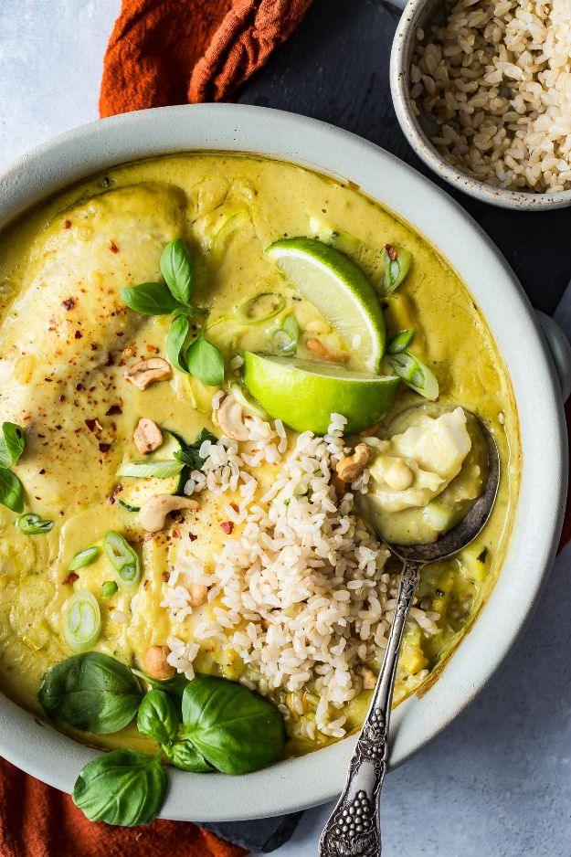 Green curry tilapia baked in coconut milk with basil and brown rice, an easy Thai style fish dinner recipe