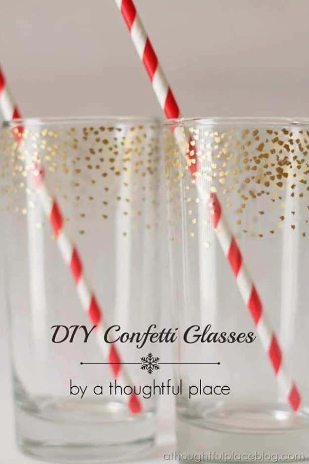 DIY gold confetti dot glass, two clear tumblers scattered with gold dots holding red and white striped paper straws