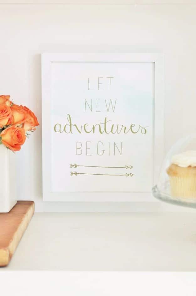 Let new adventures begin printable, grey capitals with gold script and three gold arrows over soft watercolor
