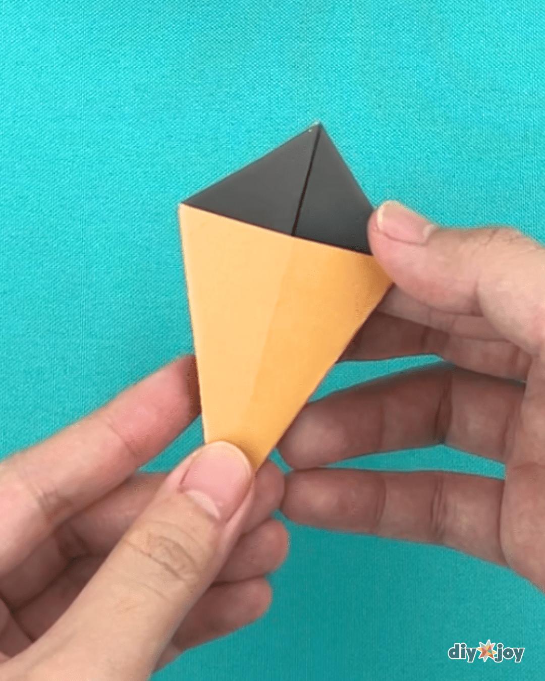 Origami lily DIY steps shown with both sides folded inward toward the center of the folded paper flower