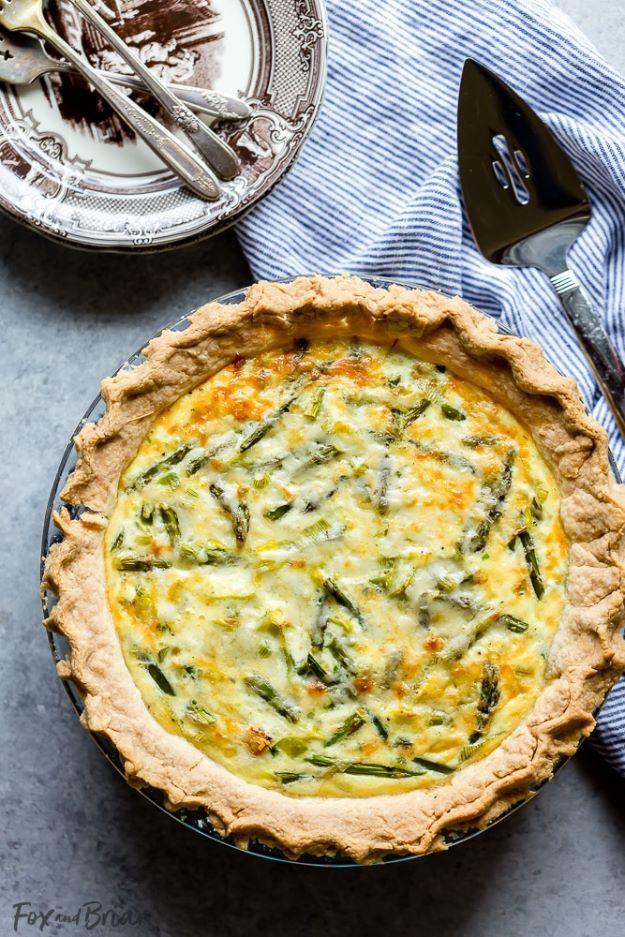 Crab asparagus and leek quiche in a glass pie dish, cream colored filling studded with cut asparagus