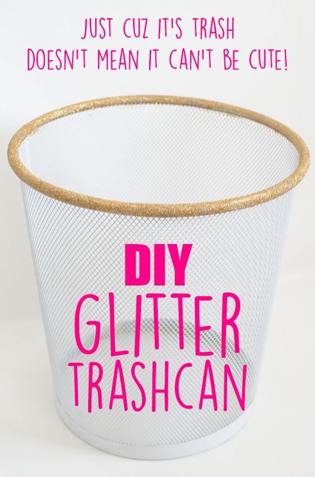 White mesh trash can with a gold glitter rim, under large typeset pink lettering on a plain wall background