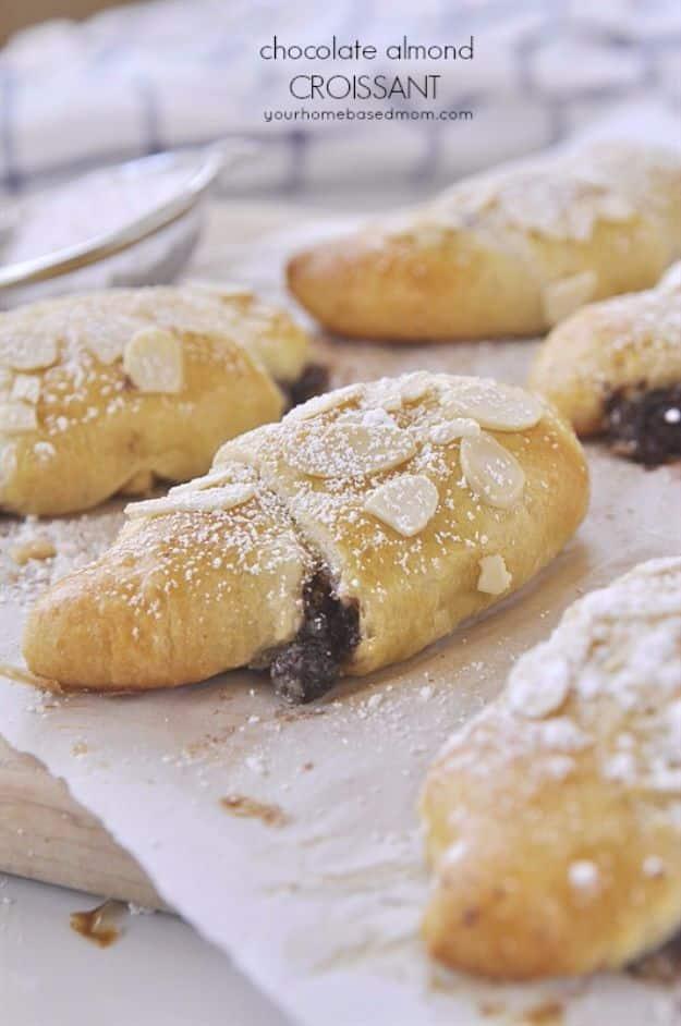 Chocolate almond croissants made with crescent roll dough, topped with sliced almonds and powdered sugar