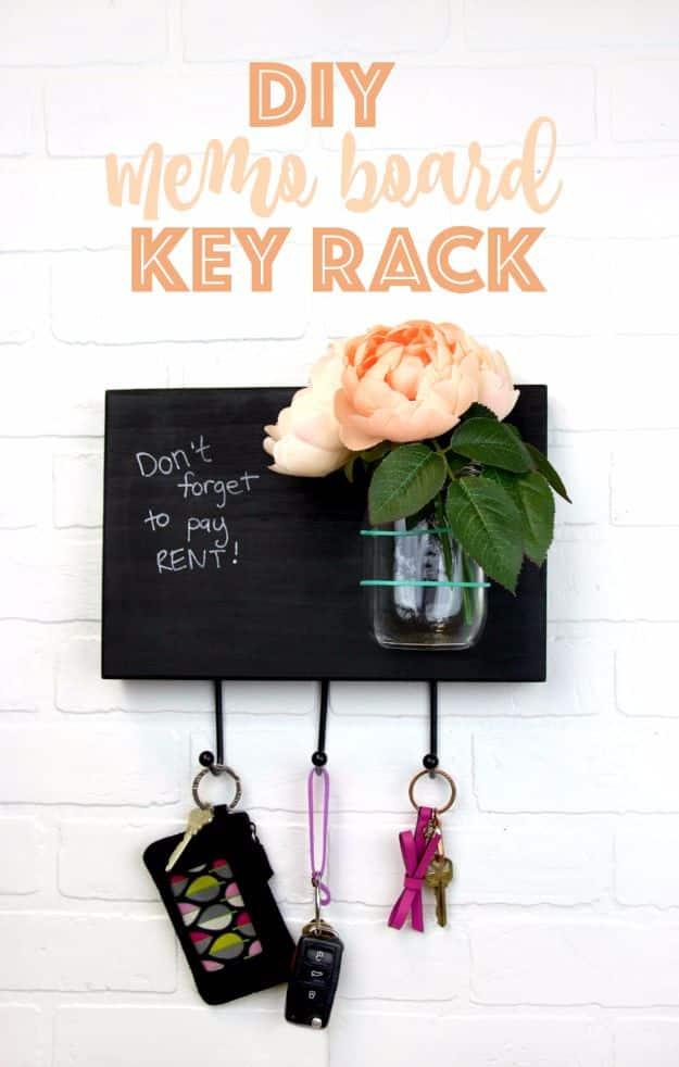 A stained wood board with a chalkboard panel and a row of small hooks hangs by a door, keys hanging underneath