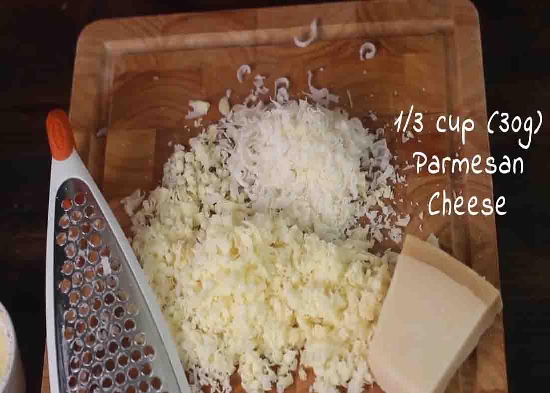 Grating cheese for the potato souffle